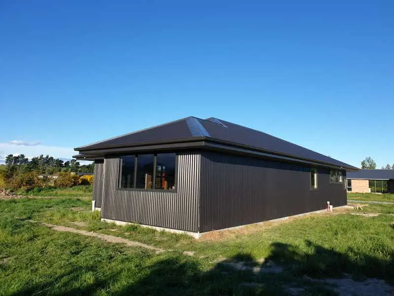 Sunlit outdoor area with wooden deck and plants
